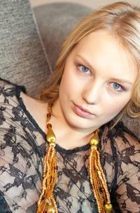 Lynne Dominates In A Tantalizing Sheer Striptease On A Couch Indoors
