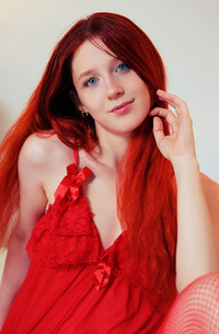 Alice teasing in red lace and fishnets, solo posing on the table, fingers sliding through her wet slit