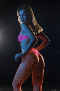 Ira Veter teases in neon lingerie and pink fishnets then strips naked and glistens wet in the dark
