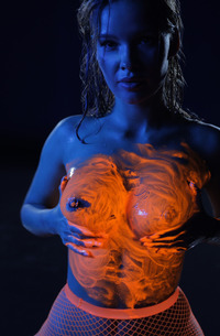 Ira Veter teases in neon lingerie and pink fishnets then strips naked and glistens wet in the dark