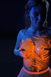 Ira Veter teases in neon lingerie and pink fishnets then strips naked and glistens wet in the dark