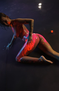 Ira Veter teases in neon lingerie and pink fishnets then strips naked and glistens wet in the dark