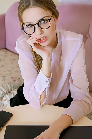 Elle Tan Puts Her Glasses Aside And Parts Her Slender Thighs So Her Short Skirt Rides Up