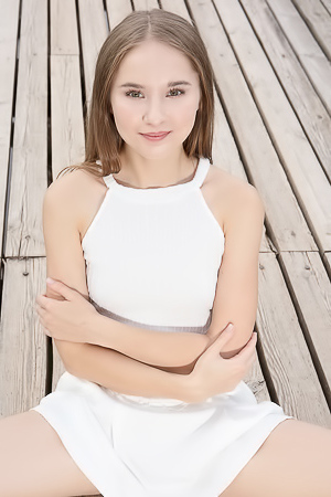 Sasha Quinn Smiling Playfully As Her Short Skirt Flips Up To Reveal She’s Not Wearing Panties