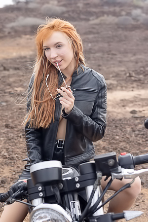Lilly Mays Rides A Motorcycle In The Desert Wearing A Leather Jacket And Miniskirt